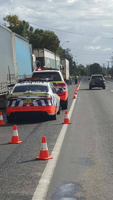 Traffic operation: Highway patrol officers inspect the loads of heavy vehicles in Boggabilla during the three-day blitz which targeted trucks and dangerous driving. 