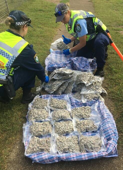 Seizure: Police with the bags of drugs on the side of the road in Boggabilla.