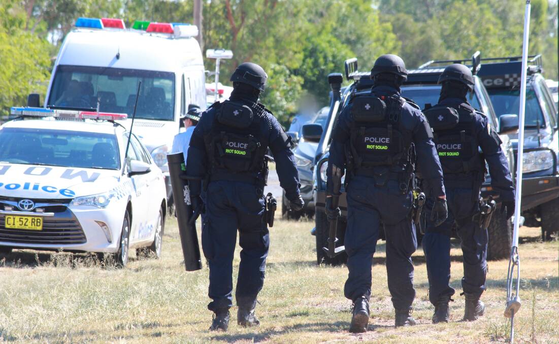 Targeted raids: Strike Force Sassafra police and the riot squad at a search warrant near Moree. Photo: NSW Police