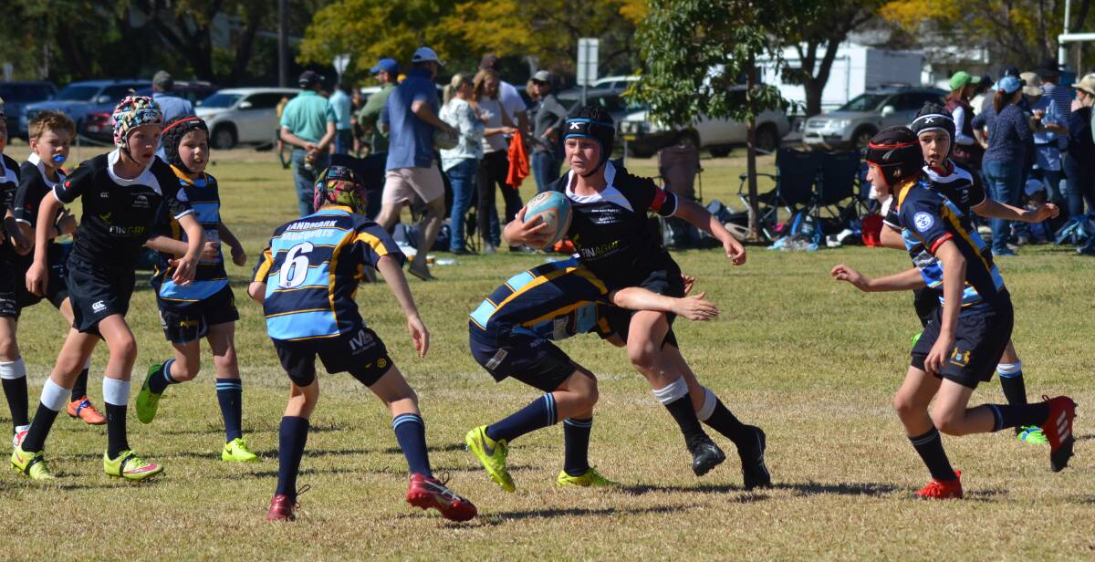 ON ATTACK: Arthur Greer runs the ball for the Moree Bulls U12s against Scone during Moree Junior Rugby Union Club's annual carnival on Sunday.