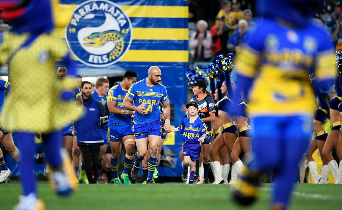 HONOUR: Moree's Curtis Cory leads the Parramatta Eels players onto the field with captain Tim Mannah during last Thursday's game against the Gold Coast Titans. Photo: Parramatta Eels