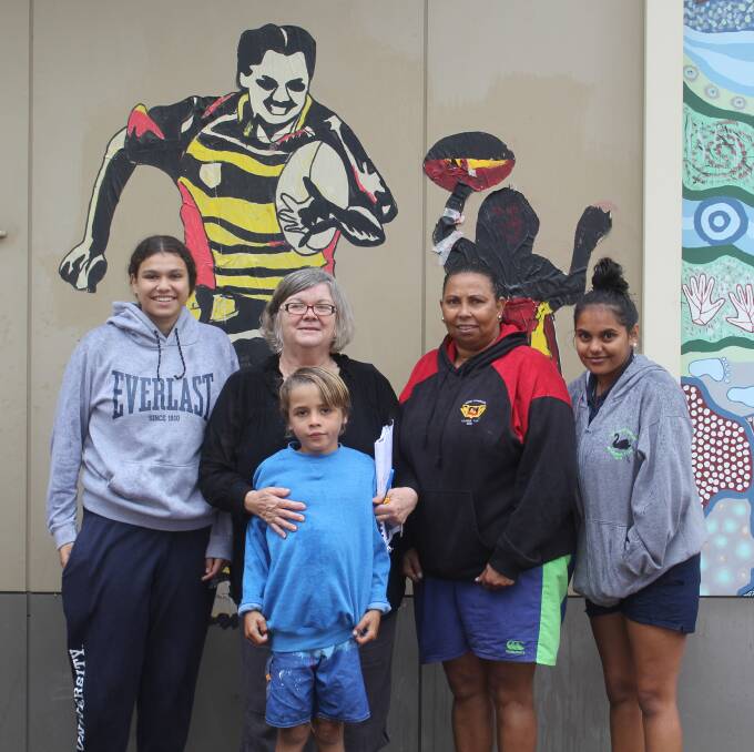 Delta Swan, Barwon Learning Centre principal Margie Hayes, Tommy, Shirley May Swan and Shanika Hippi in front of one of the paste ups on the wall of Barwon Learning Centre.
