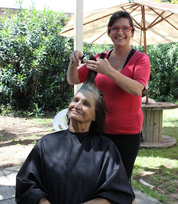 BOOSTING SELF-ESTEEM: Kaz Collins gives Wendy Craigie, one of the Moree Plains Gallery art students, a brand new hairstyle while she was in Moree last week.