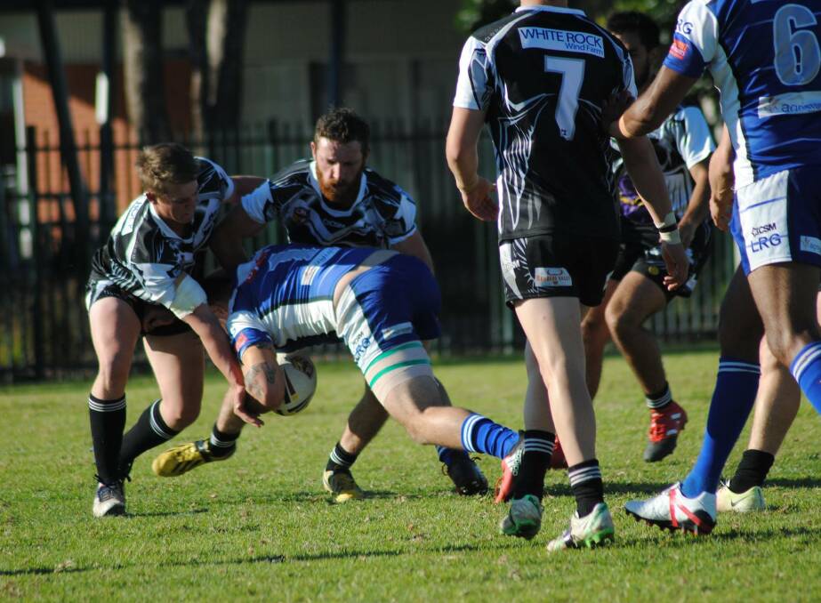 STANDOUT: Conor Ryan dives for the try line as two approaching Magpie players attempt to hold him up during the first grade match on Sunday. Photo: Deb Holland.