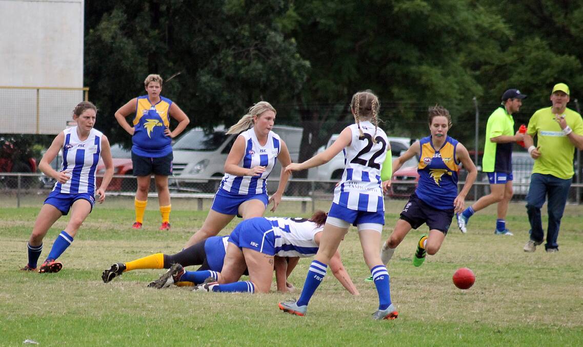 FIGHT FOR THE BALL: Jess Maher chases the ball, while Dannielle Jukes tries to fend off the opposition on the ground. Photo: Haley Caccianiga 