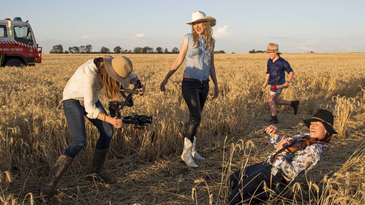 Sascha Estens filming one of the scenes in her QantasLink My Town Spirit entry, featuring Rabbit Hop Films' Merri-May Gill and Fi Claus. Photo: Bruce Tindale