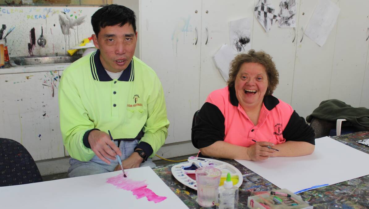 FUN WITH COLOURS: Malcolm Lee and Jill Campbell enjoy participating in weekly art classes at Moree Plains Gallery.