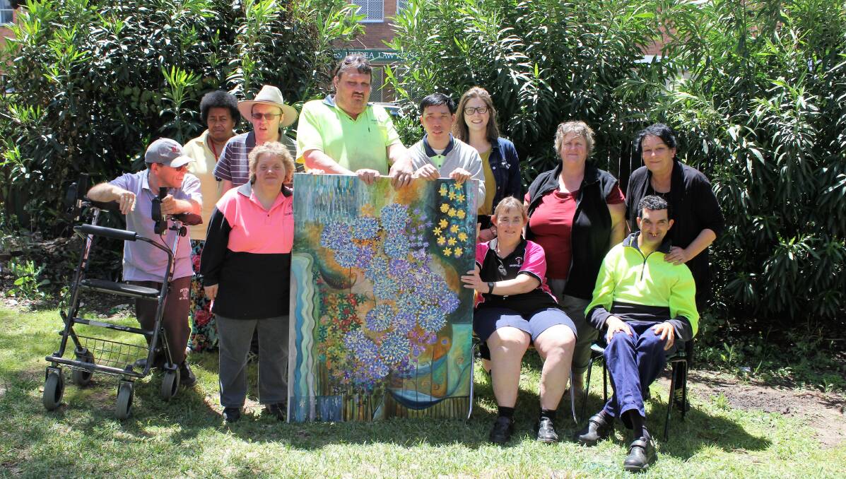 (Back) Lusi Turago, Adrian Oppenheimer, Aaron Brady, Malcolm Lee, Moree Plains Gallery curator Hannah Williamson, Gwydir Industries supervisor Vera Jackson, Moree Plains Gallery education officer Janelle Boyd, (front) Ross Clarke-Bruce, Jill Campbell, Leanne Rohde and Gregory Haddad with the beautiful artwork they created which is set to be raffled.