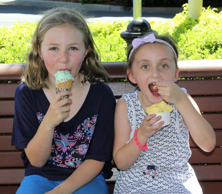 KEEPING COOL: Amelia Powlton and Maddie Lumb enjoy some delicious ice-cream from Sullivan's Newsagency on Wednesday. 