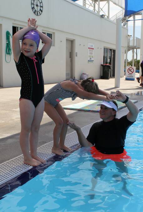 Chloe Turnbull and Maggie Brown practise their diving skills with learn to swim instructor Julie Rushby at Moree Artesian Aquatic Centre.