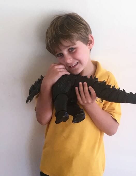 REUNITED: Fred Hughes was over the moon to get his beloved Godzilla back, after losing the toy on a Manly ferry.
