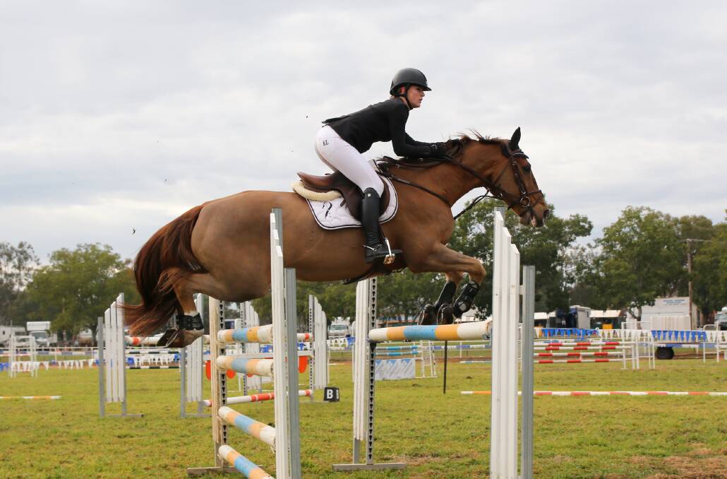  Emma Botfield riding her beloved horse Norton at Gunnedah Showjumping Festival in June this year. Emma's family and friends would love to see people share their own jumping photos, using the hashtag #Jump4Em.