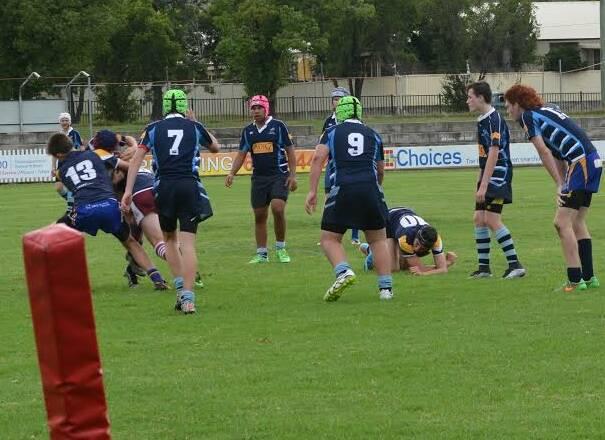 MAKING A MARK: St Philomena's student Jock Brazel (number 13) tackles another player during the northern region rugby league trials in Tamworth on Tuesday.