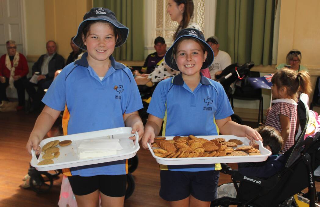 Girl Guides: Bella Fernance and Lucy Kilner handing out Anzac biscuits to residents after the main service on Tuesday.