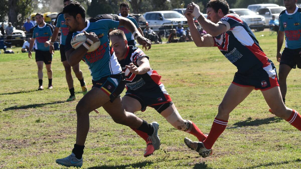 On the hunt: Macintyre fullback Malcolm McGrady busts through the ashford defence in the preliminary final win last week as the warriors prepare for the grand final.