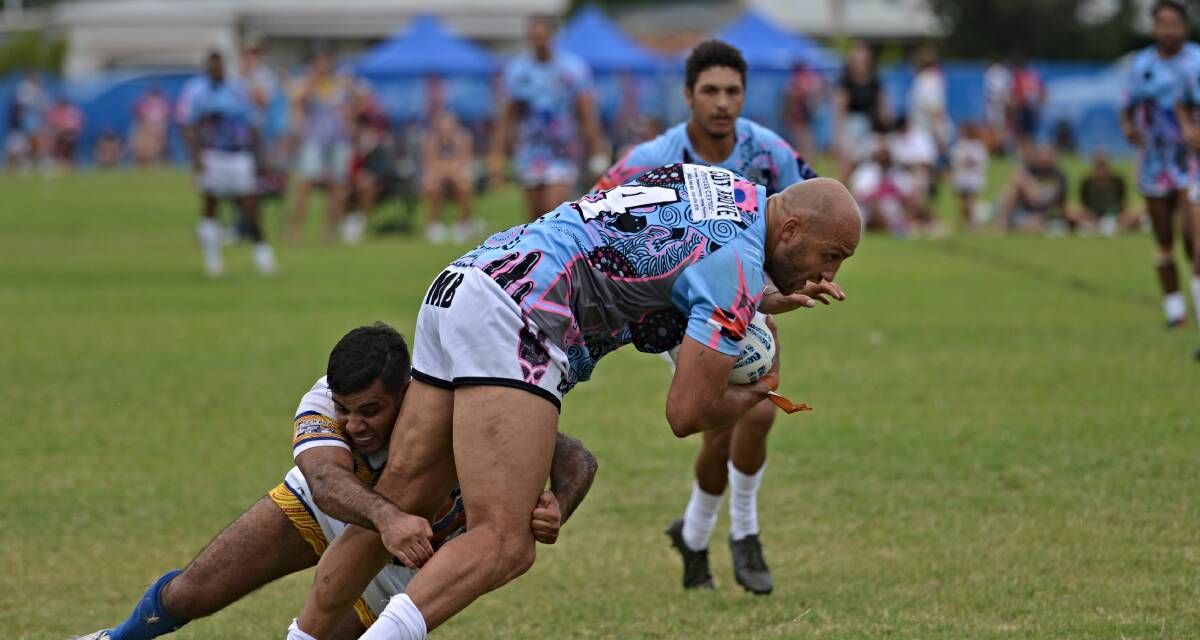 Barker brings down former Blues stars Blake Ferguson at the Western Challenge. Picture by Mark Bode