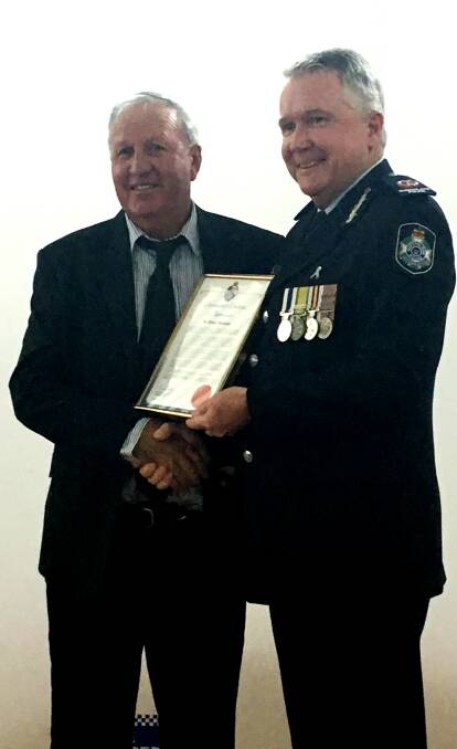 Moree's Jimmy Bateman is presented a certificate of appreciation by assistant Queensland Police Commissioner Tony Wright.