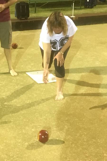 Lined up: Barefoot bowler Kerry Gooda 'on the drive' during a social bowls night at the Moree and District Services Club. Bowling is about strategy and accuracy.