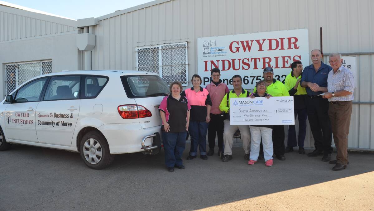 The Gwydir Industries team with Eric Carrigan and Wayne Hamilton handing over the official cheque. 