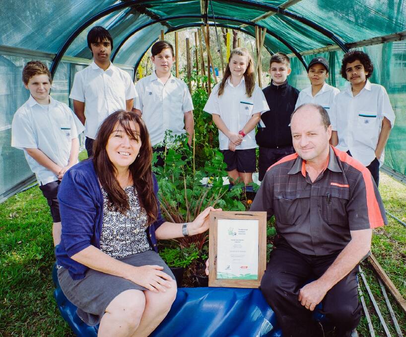 Green Thumbs: Craig Pritchard, Bridgestone Moree assistant store manager, and Peta Gallagher, environmental teacher, with students from Moree Secondary College.