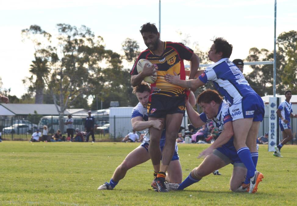 Tackle: Moree Bomerang Warren Cain fights off the Moree Boars defense in first grade on Sunday at Boughton Oval.