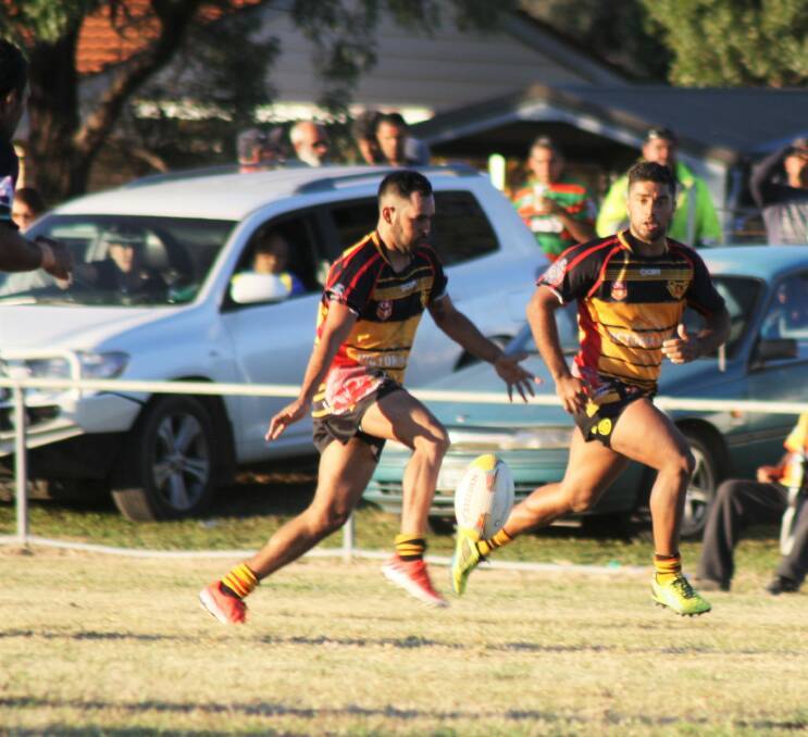 First grade: Moree Boomerangs player Jamie Sampson kicks the ball with Kyle Saunders in support.
