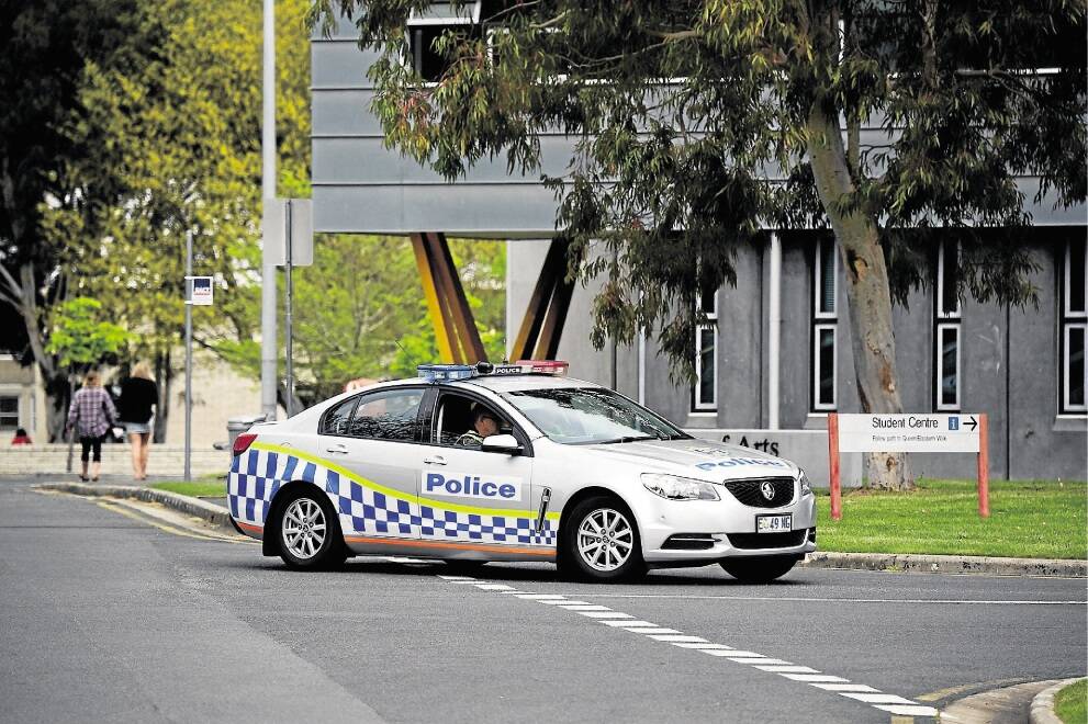 A police vehicle outside the University of Tasmania's Launceston campus after security was beefed up following an online threat. Picture: PAUL SCAMBLER