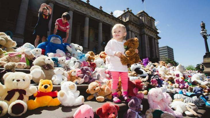 Teddy bears are placed on the steps of Parliament House to symbolise the victims of domestic abuse. Photo: James Boddington