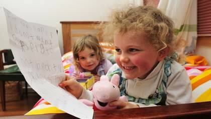 Peppa Pig fan, Tess Coventry, 5 with the letter that she wrote to the paper hoping that Peppa Pig wouldn't be taken from her tv because her sister India, 2 would be sad. Photo: Melissa Adams