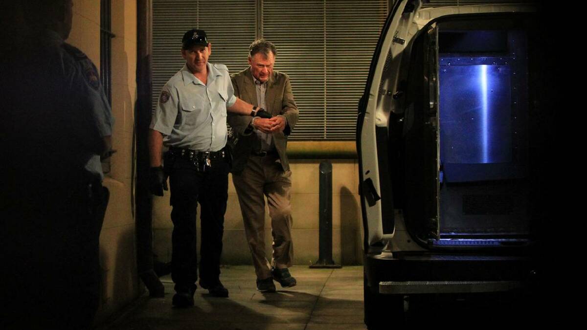 ACCUSED: Ian Robert Turnbull leaves the King St Courts surrounded by prison guards. Photo: James Alcock