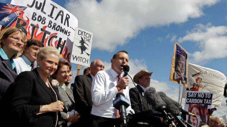 Then opposition leader Tony Abbott in front of a "ditch the witch" poster at a rally outside Parliament House in 2011. Photo: Andrew Meares
