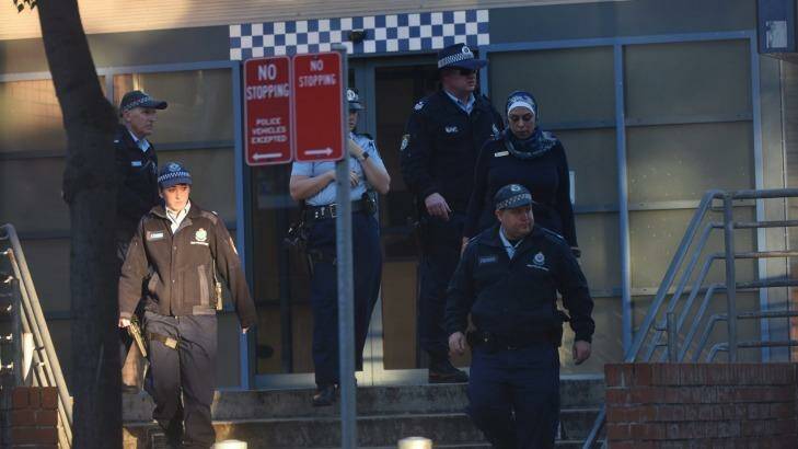 Police at Merrylands Police Station after Thursday night's attack.  Photo: Nick Moir