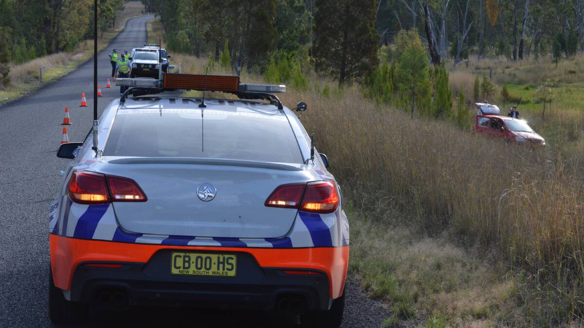 ARREST: Police and detectives at a second crime scene on Copeton Dam Rd, where a man was arrested and a vehicle seized for forensic investigation, after it crashed yesterday afternoon. Photo: Harold Konz.