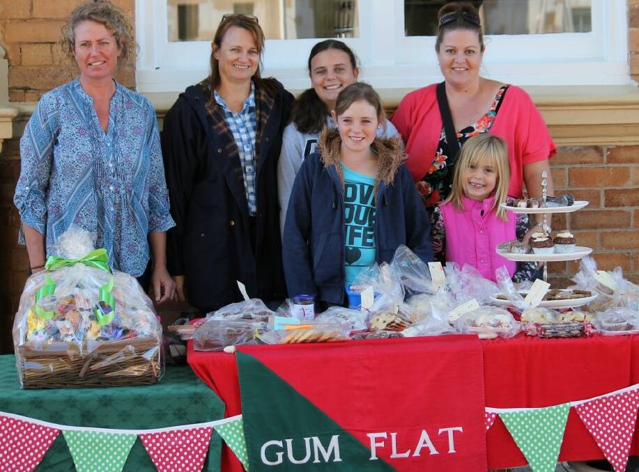 CAPTIVE CUSTOMERS: Gum Flat cake and Easter raffle table was manned by (l-r) Jennie Lindsay, Penny, Mia and Beth Hackney with Madison and Alanna Carse.