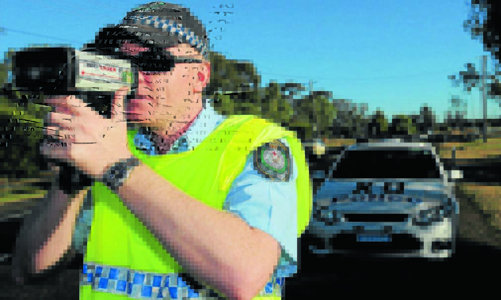 BLITZ: Highway patrol Senior Constable Richard Hooley tests driver speed along Scott Rd during a police operation. Photo: Geoff O'Neill