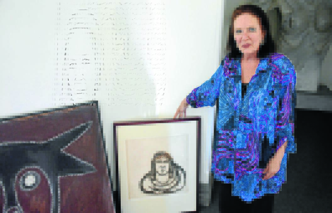  Katrina Rumley with a lithograph by Brett Whiteley and painting by Rover Thomas which were among the 25 works recently donated to the gallery by Simon and Julie Ford. 