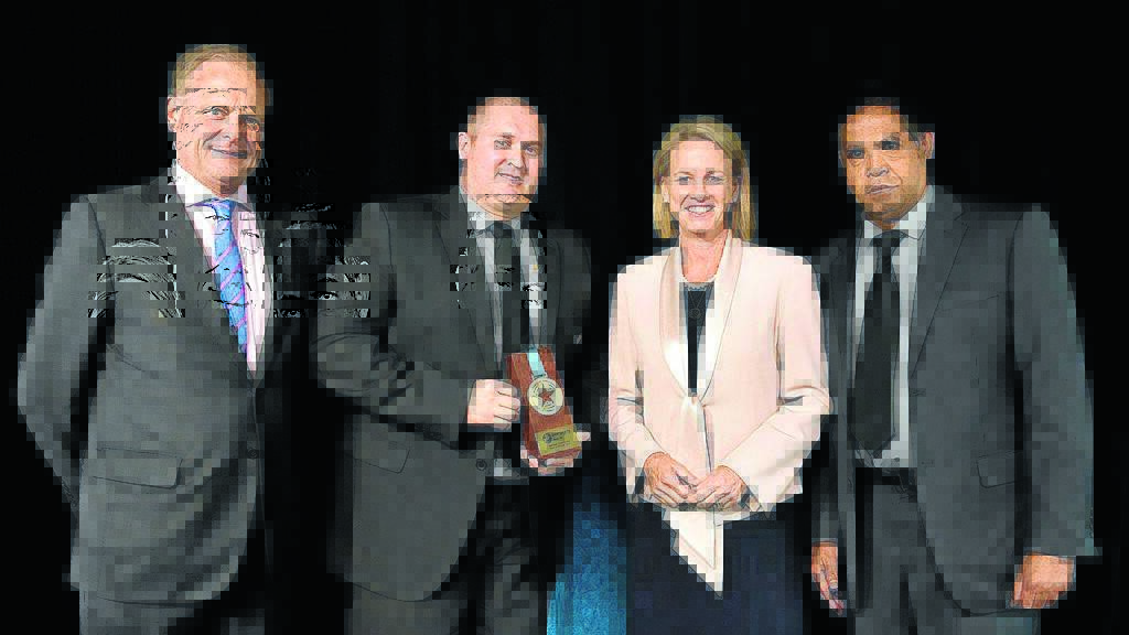 President Mitchell Johnson (second from left) accepts the award.
