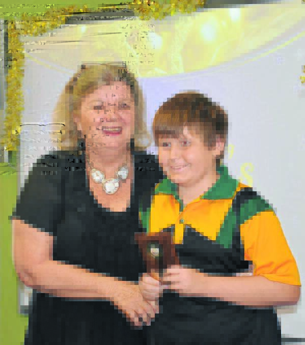 Margie Hayes gives Bowen Griffith the principal's award.