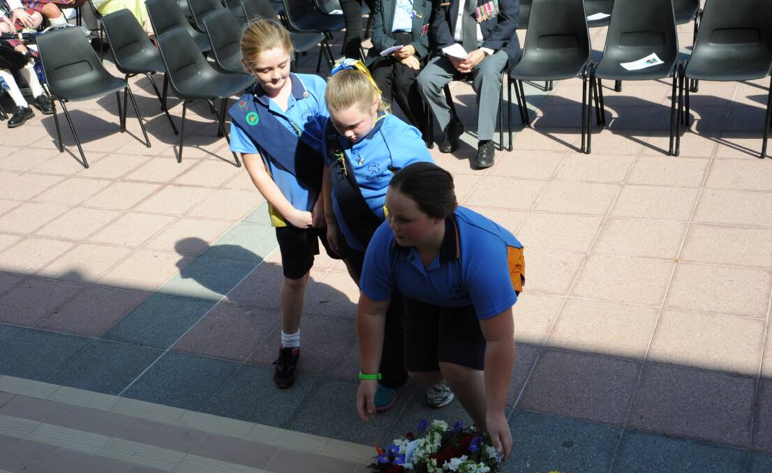 Girls scouts laying their wreath