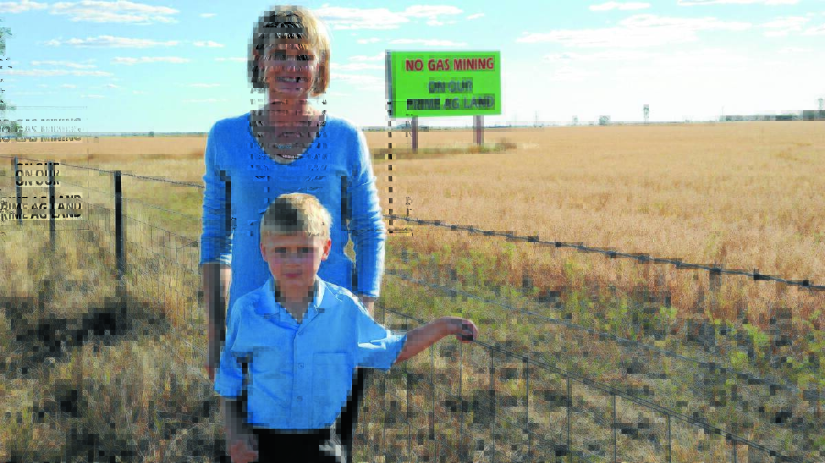 Penny and Jeremy Blatchford with the iconic anti-CSG sign on the Newell Highway, south of Moree.
