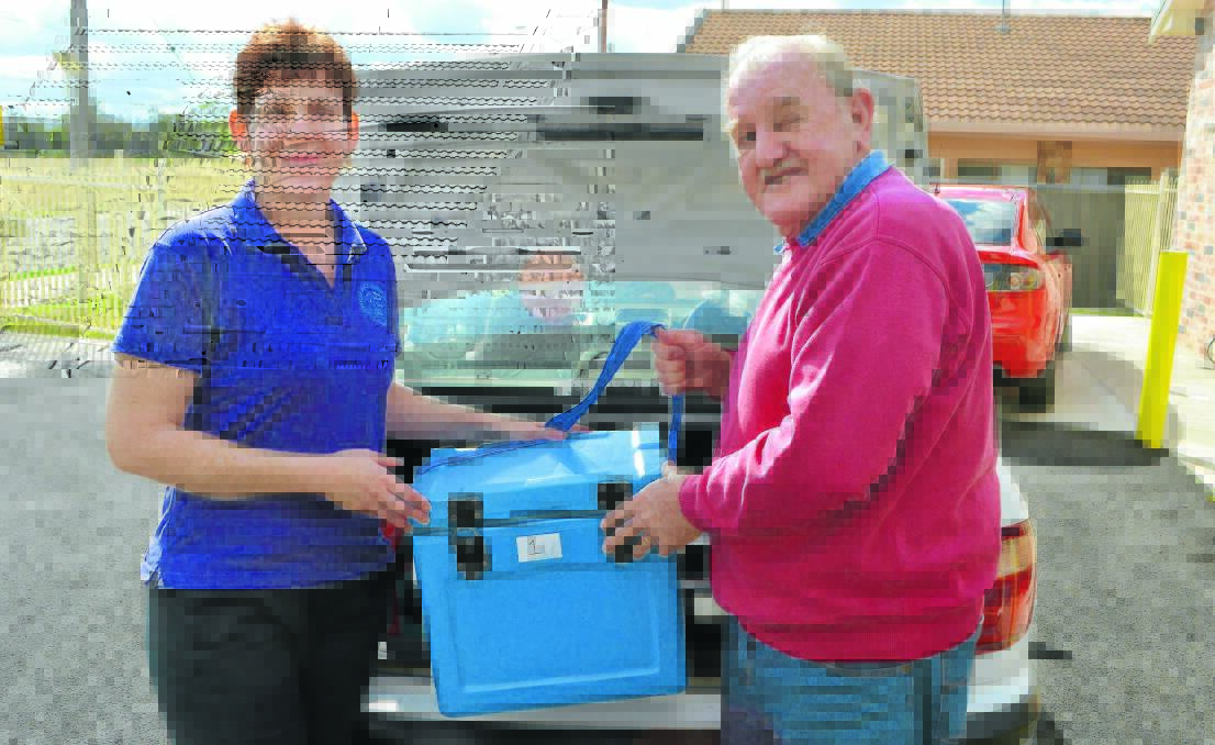 Moree Meals on Wheels food services officer, Rachel Egan, and volunteer Les Lines pack the esky in the car for another trip.