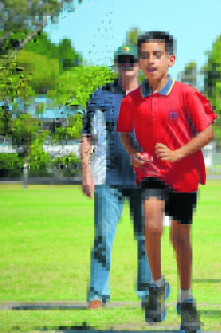 Brad Swan practises his bowling technique under the watchful eye of Dennis Lillee in Moree on Tuesday.