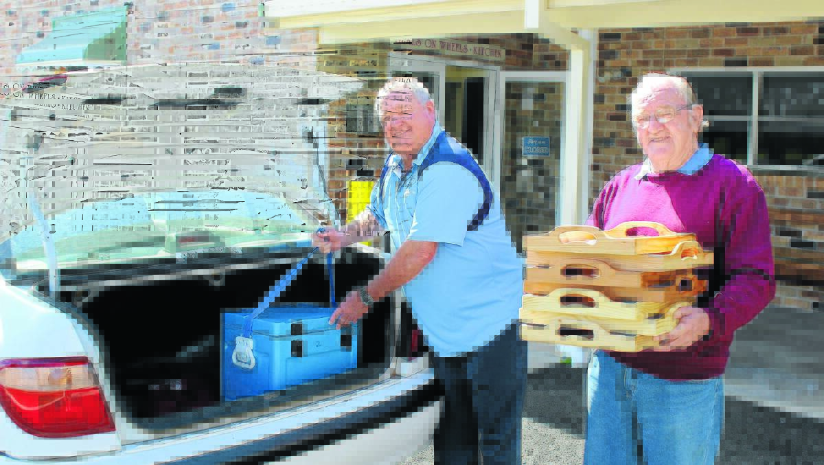 LENDING THEIR TIME: Volunteers for Meals on Wheels Darryl Brady and Les Lines helping the community.