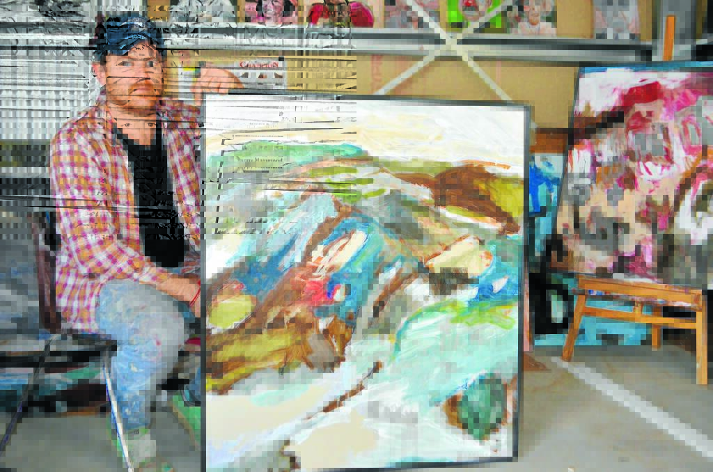 Moree artist, James Kearns, with two of his new paintings.