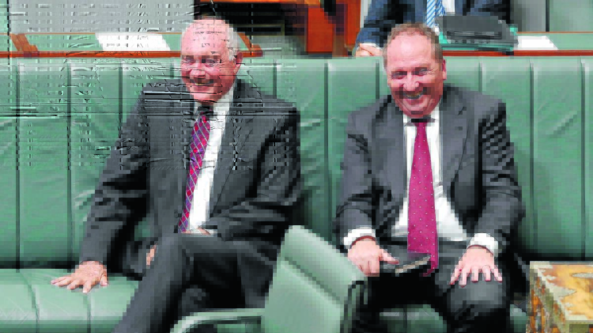 PASSING THE BATON: The former Nationals leader Warren Truss and the new leader Barnaby Joyce share a laugh in parliament yesterday. 