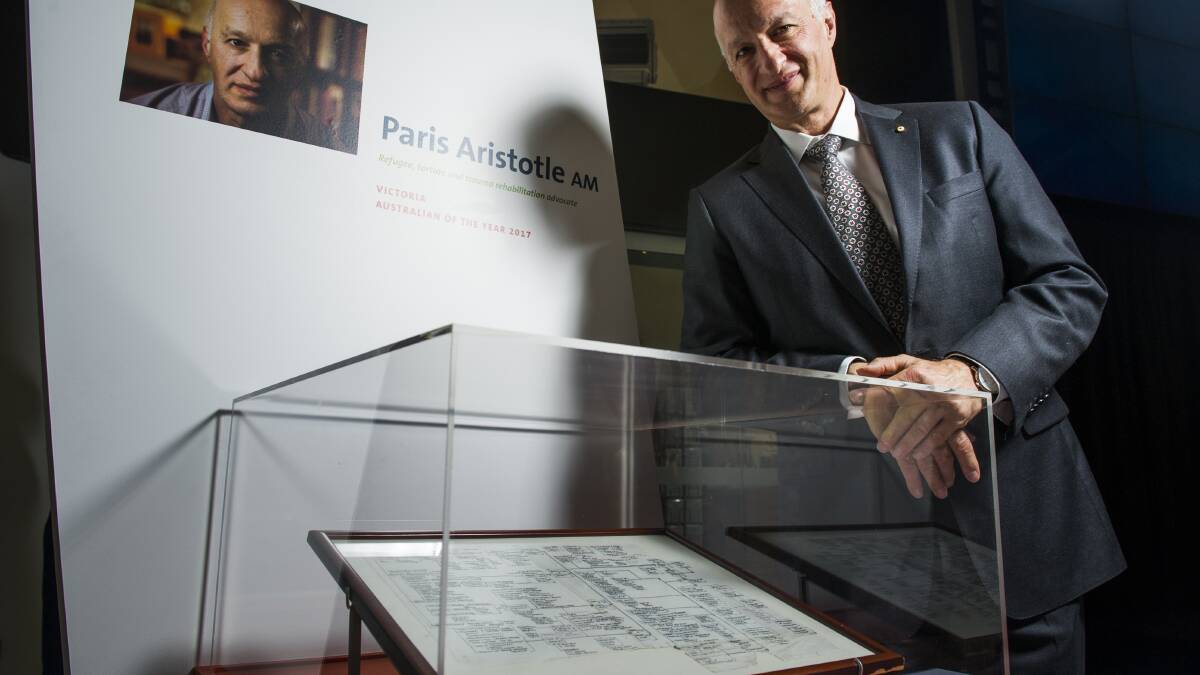 Victoria's Paris Aristotle, anti-torture and refugee advocate, with his personal object on display at the National Museum in Canberra, the "Mind Map" sketched in 1987 by John Gibson. Photo: Elesa Kurtz