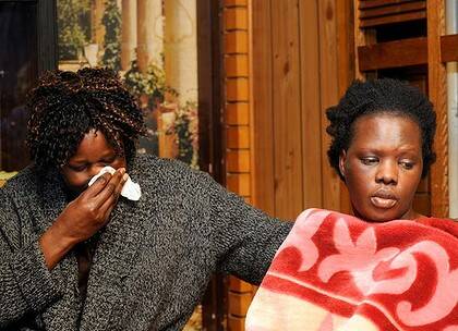 Grief ... Ayen Chol's mother, Jackline Anchito, right, pictured with her cousin, Aweng Mathok, ran into the street screaming for help after the dog attacked her daughter on Wednesday night.