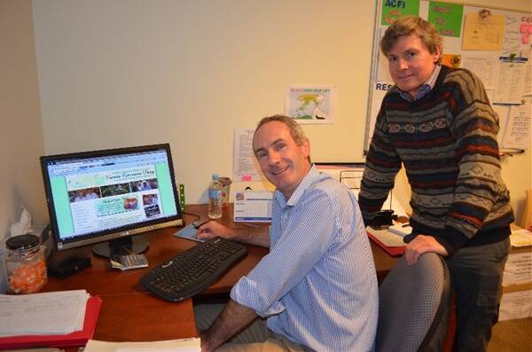 Fairview CEO Brett Arthur and chairman Chris Humphries scrolling through the new website.