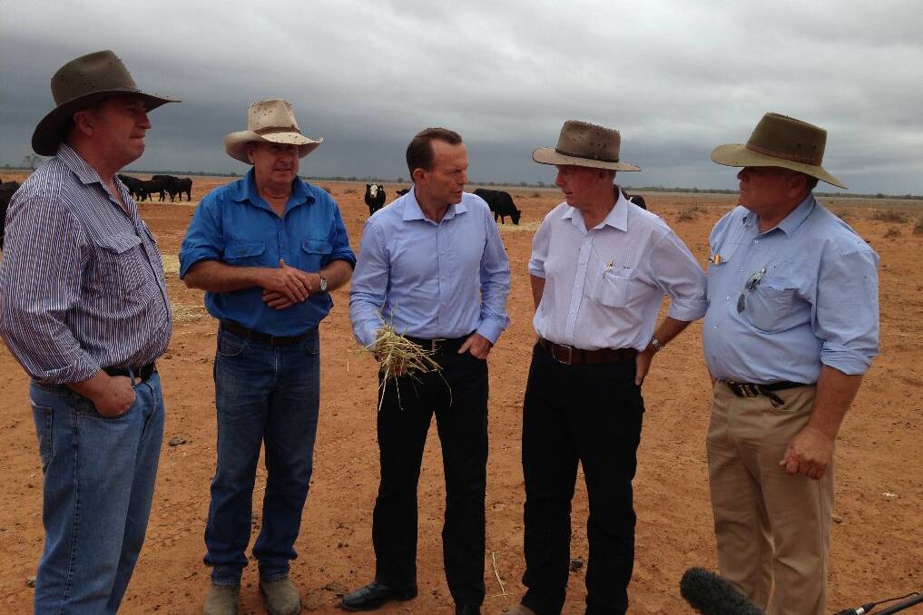 Minister for Agriculture, Barnaby Joyce, grazier Phillip Ridge, Prime Minister Tony Abbott, Parkes MP Mark Coulton and Bourke Shire Council mayor Andrew Lewis inspect a Bourke property.