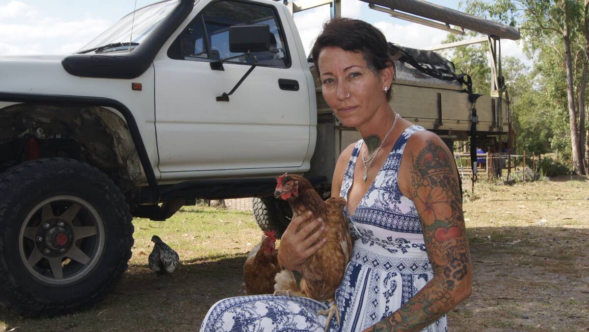 REUNITED: Melonie-Jane McNaughton reunited with her chicken Dora after it was found perched on the diff of a moving Toyota ute. Photo: Jacob Wilson